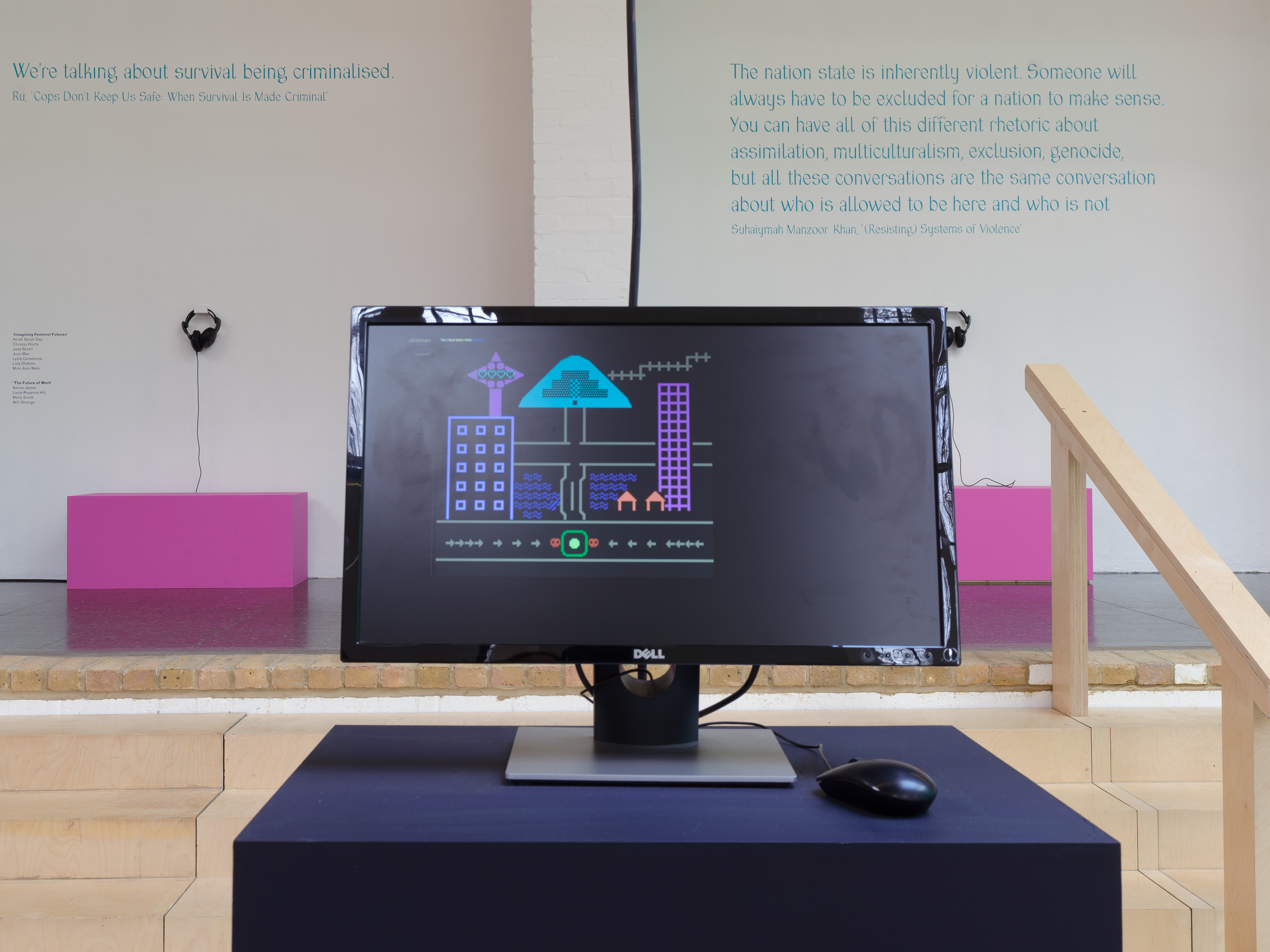 A computer screen sits on top of a black plinth, with a game on it designed by Cory Cocktail.
