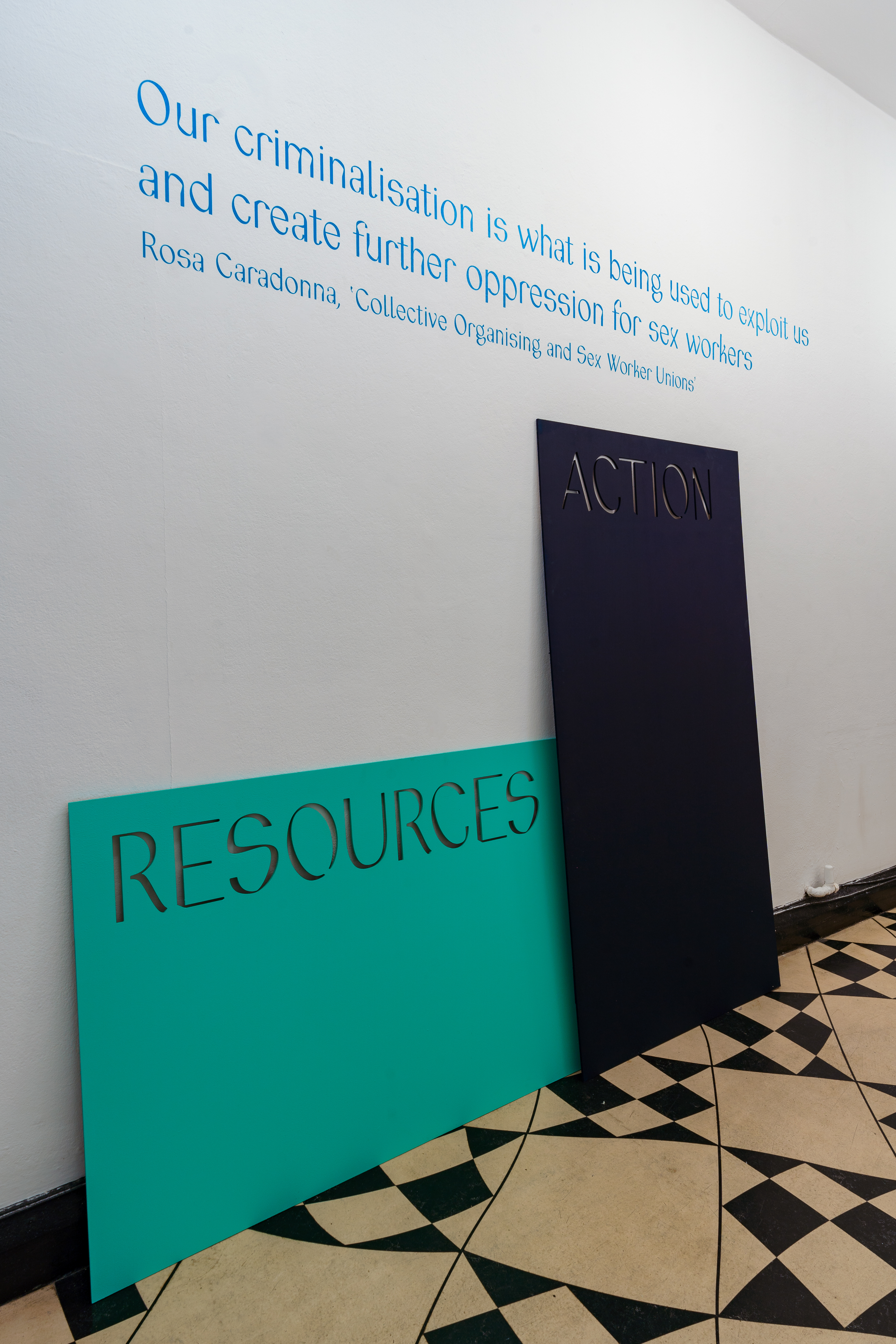 A white wall features the text 